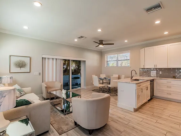 Open floor plan with sliding door to screened in sunroom