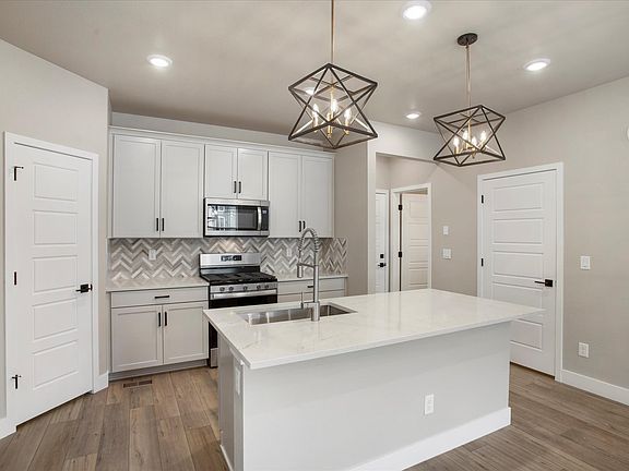 The Keystone s designer decorated kitchen spills into the dining room allowing for an open feel.