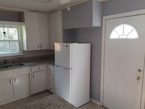 Kitchen with rear exit to patio and fenced yard