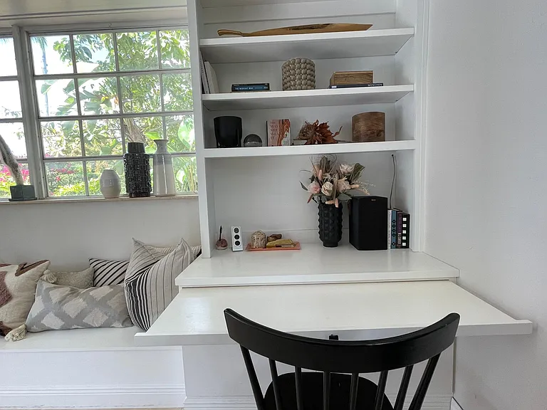 Pull out drawer becomes a desk when needed. If not it's a clean look bookcase.