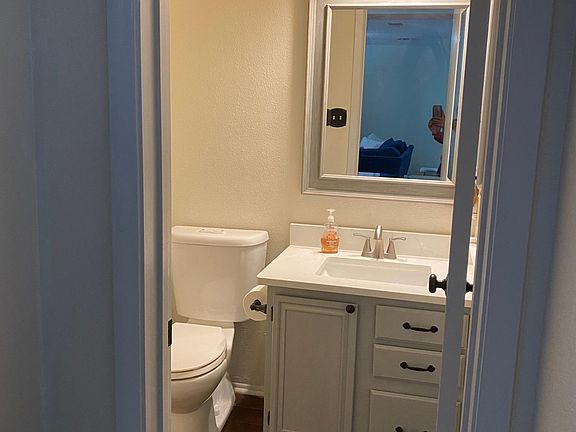 Updated half bathroom with new mirror and fixtures.