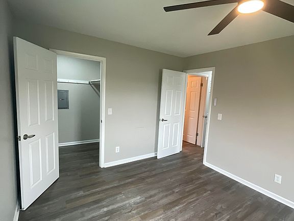 Bedroom #1 with large walk in closet. New flooring, paint, doors, ceiling fan/light