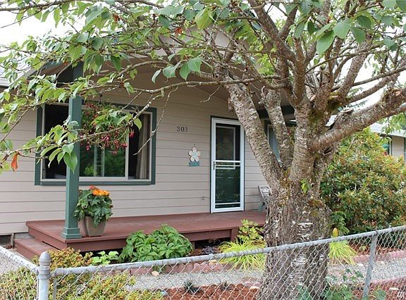 Charming covered porch greets visitors.