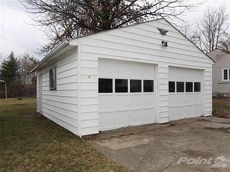 The 2-car detached garage offers an abundance of storage and a side entry door.