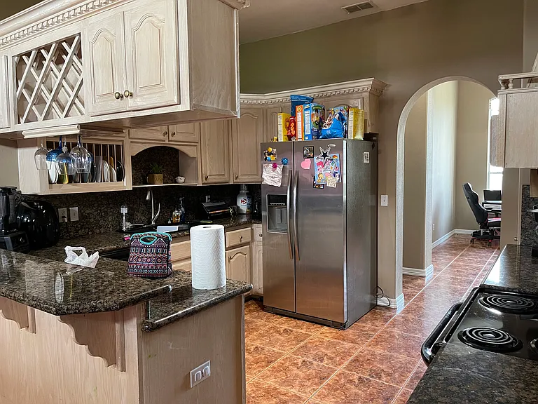 Spacious kitchen with plenty of cabinet storage, a large countertop area, and open sightlines to the dining and living spaces _ perfect for everyday cooking and family gatherings.