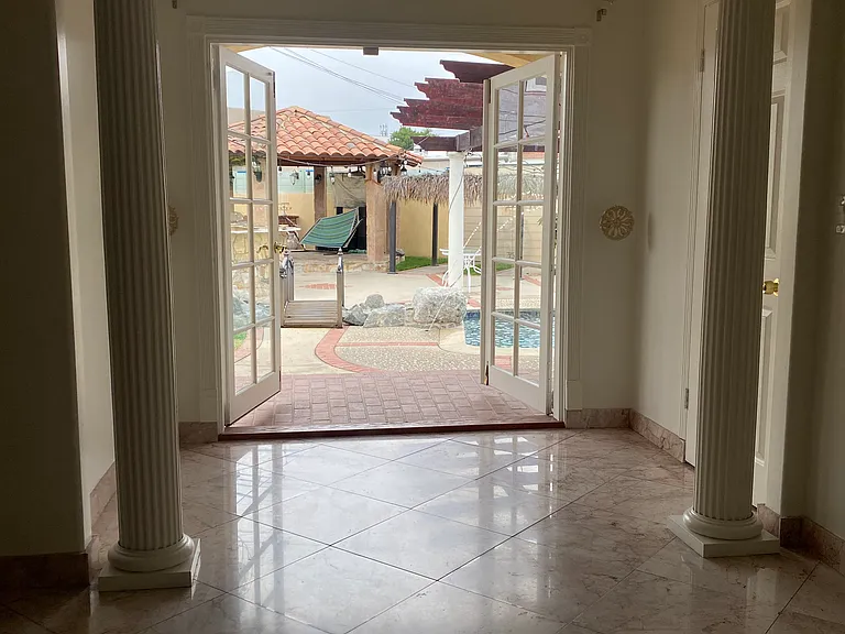 Master Beedroom with covered Porch and pool view.