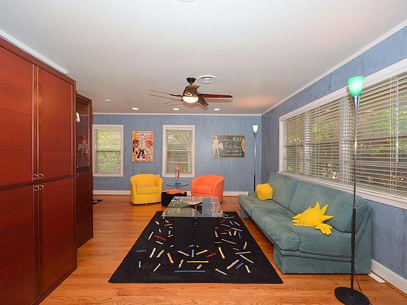 This family room/den is huge! Large picture windows overlook the landscaped front lawn. Features inc