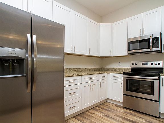 New stainless appliances in open kitchen