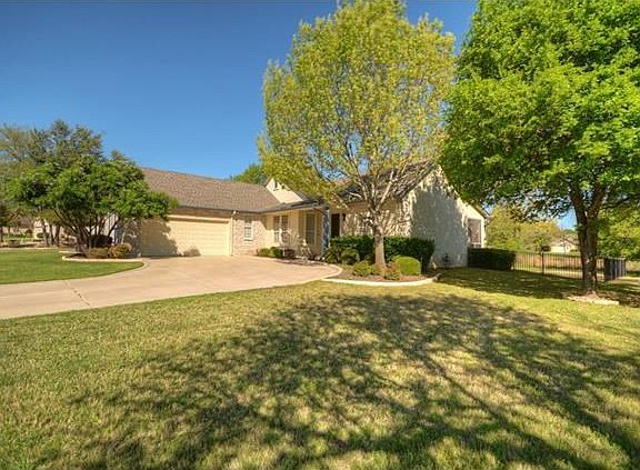 A wide greenbelt lot and Swing-Entry Garage welcome you to this charming Sun City Texas Brazos Premi