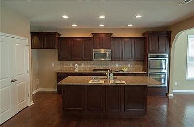 This spacious living room would be a great playroom or office.