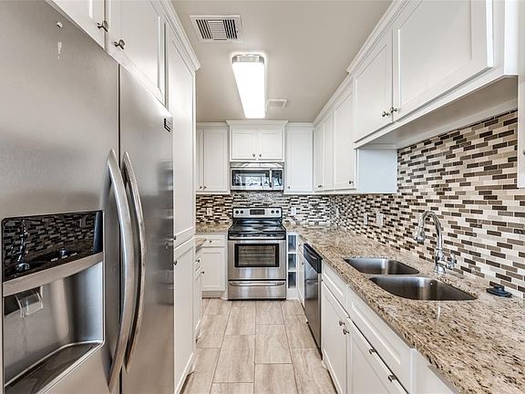 Beautiful kitchen with all SS appliances, granite counter tops, and lovely backsplash that adds a dramatic touch of color.