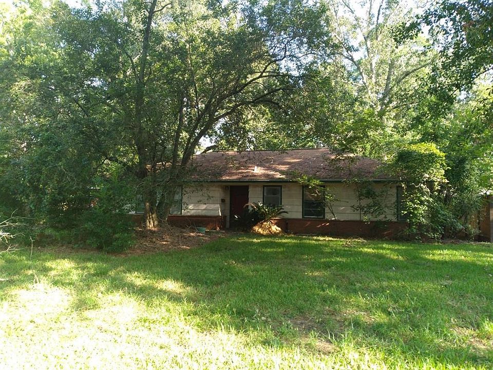 Front of home on a large, beautifully, treed lot.