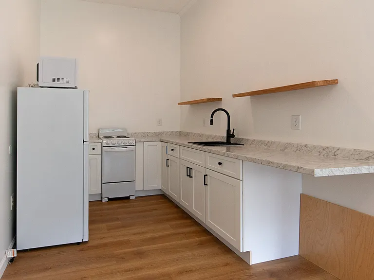 Electric Stove/Oven Range, Sink, Lower Cabinets, Floating Shelves