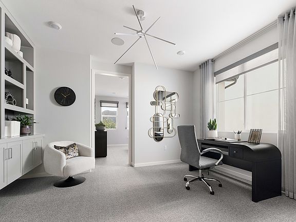 A modern, minimalist home office space with white walls, a black desk, and various decorative elemen