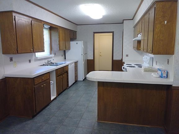 Eat-in kitchen with breakfast bar includes refrigerater, dishwasher and stove. The large laundry off the kitchen includes the washer and dryer.