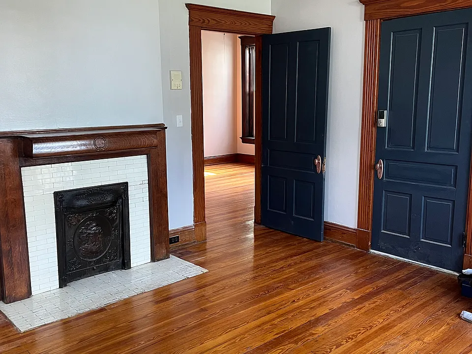 View of the entry door and the door into the bedroom from the Living room.