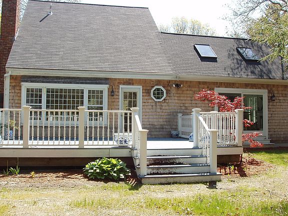 back of house with deck