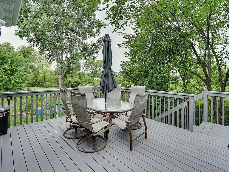 Deck covered with trees and overlook wetland/preserved backdrop