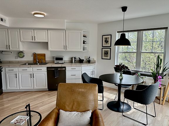 Modern chef's kitchen with new appliances, ample cabinetry & stainless steel cookware.