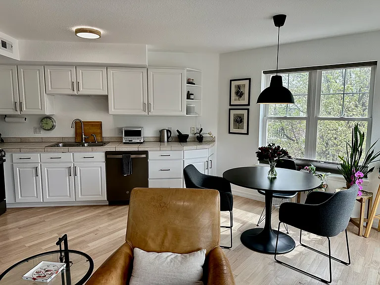 Modern chef's kitchen with new appliances, ample cabinetry & stainless steel cookware.