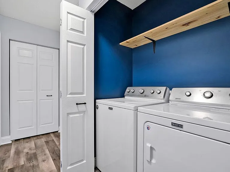 Laundry closet with large washer & dryer and sturdy shelf above