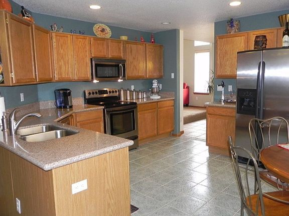 The kitchen features granite countertops and stainless appliances.