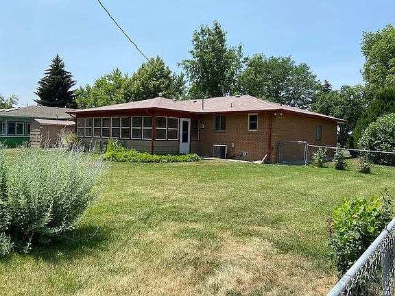 Backyard view of the sunroom and shed