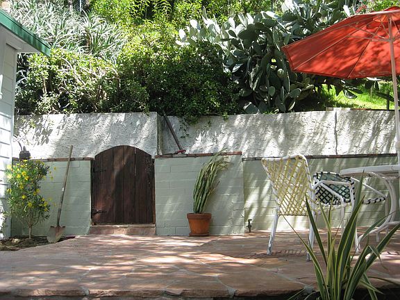 Your vast patio includes the private hillside retreat behind.