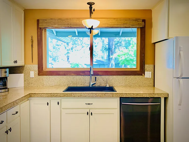 A large kitchen window overlooks the front yard and neighborhood.