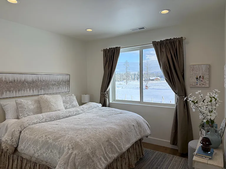 One of the additional suites featuring beautiful mountain views and a king-size bed shown for staging purposes only, creating a peaceful and inviting retreat.