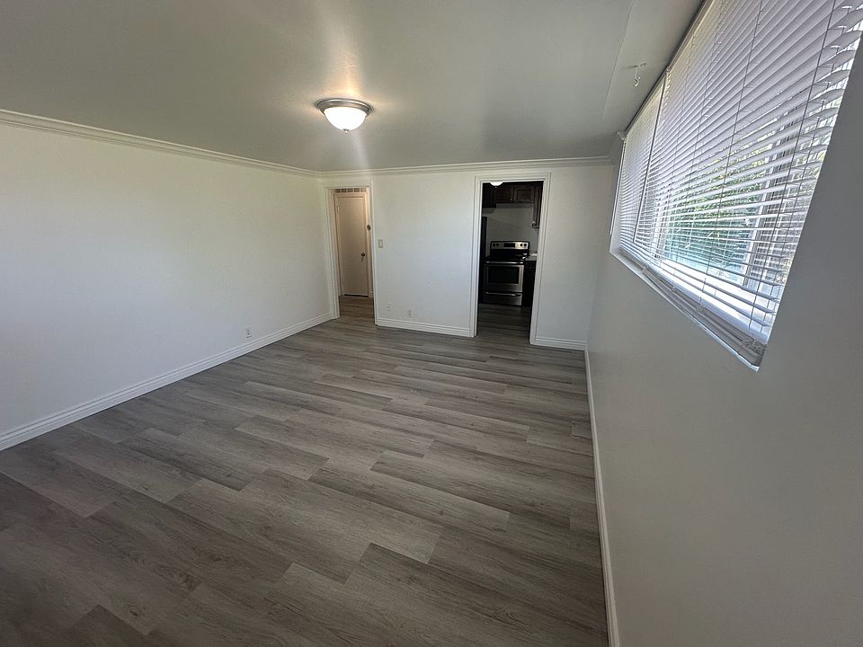 Large Family Room with lots of Natural Light and Brand New Flooring