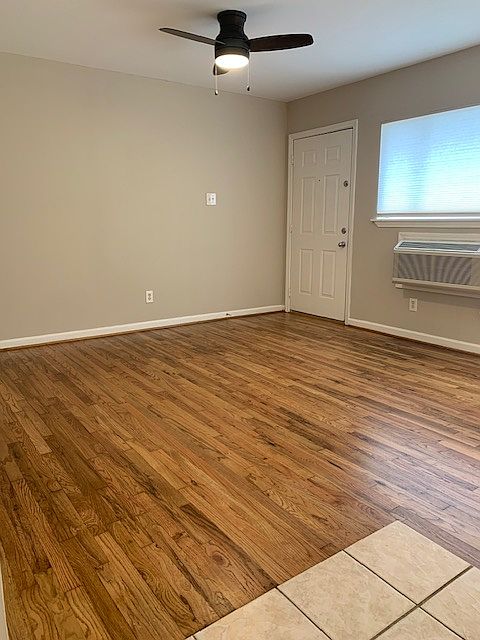 Living room features: Sleek ceiling fan, high-efficiency wall AC/heat