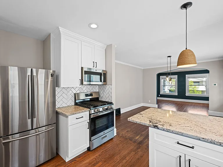 This photo shows the home's open concept/how the kitchen leads directly into the dining room.