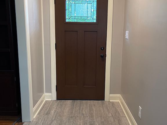 Entrance to the home. Living room is on the left of photo. Dining and kitchen are straight ahead. Bath is to the right.