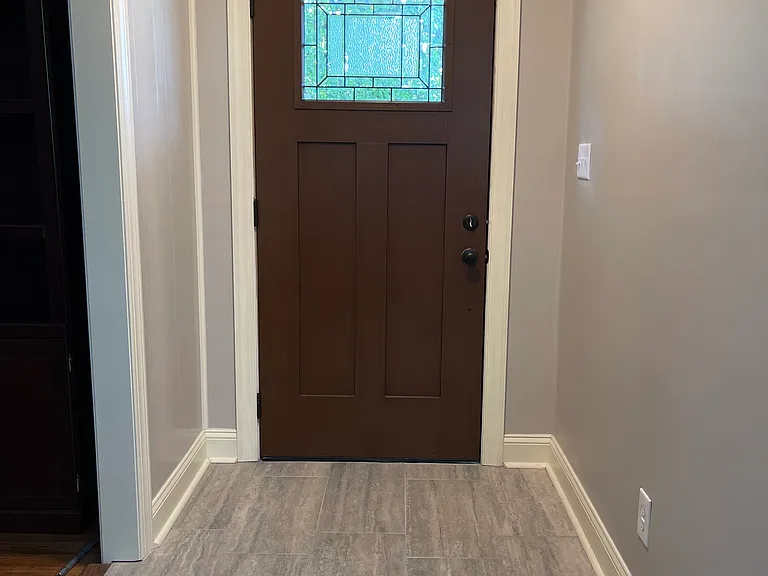Entrance to the home. Living room is on the left of photo. Dining and kitchen are straight ahead. Bath is to the right.