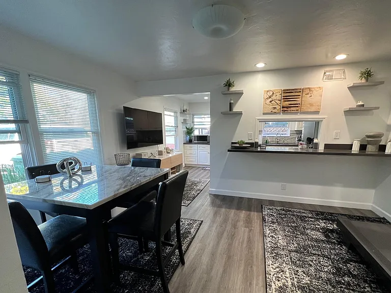 Dining room area with kitchen pass-through. All new floors and lighting