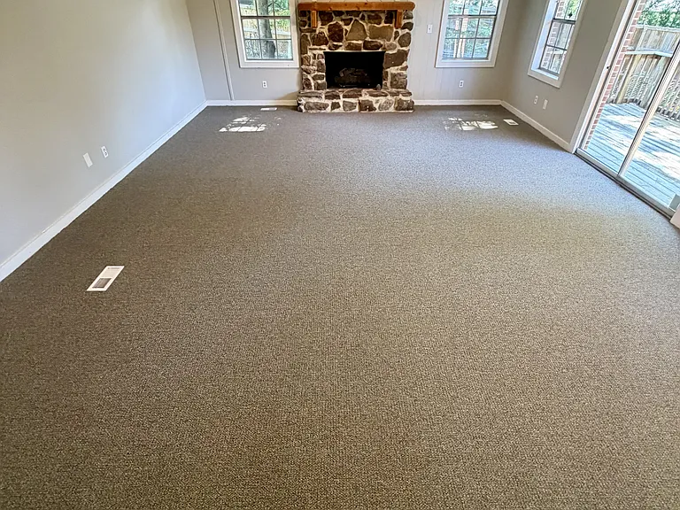 Large living room & fireplace, view from kitchen area, to the right is the back porch