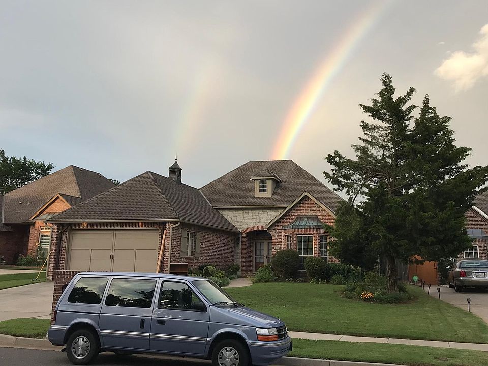 Front of the house with beautiful front yard and double rainbows.