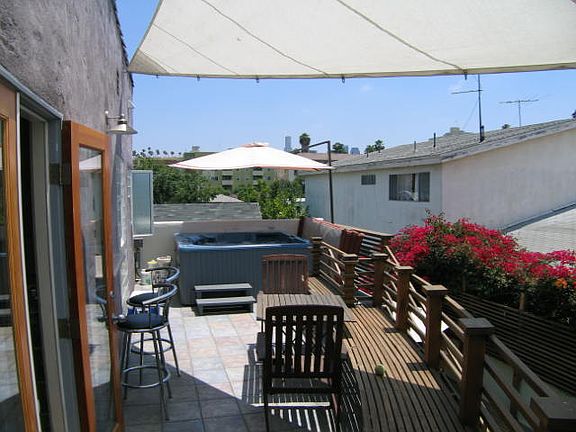 Jacuzzi spa on private deck with sunbrella