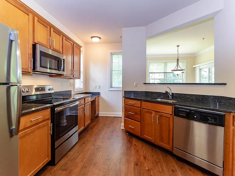 Modern upgraded kitchen featuring sleek appliances and stylish finishes at Claremont Apartments in Exton, PA