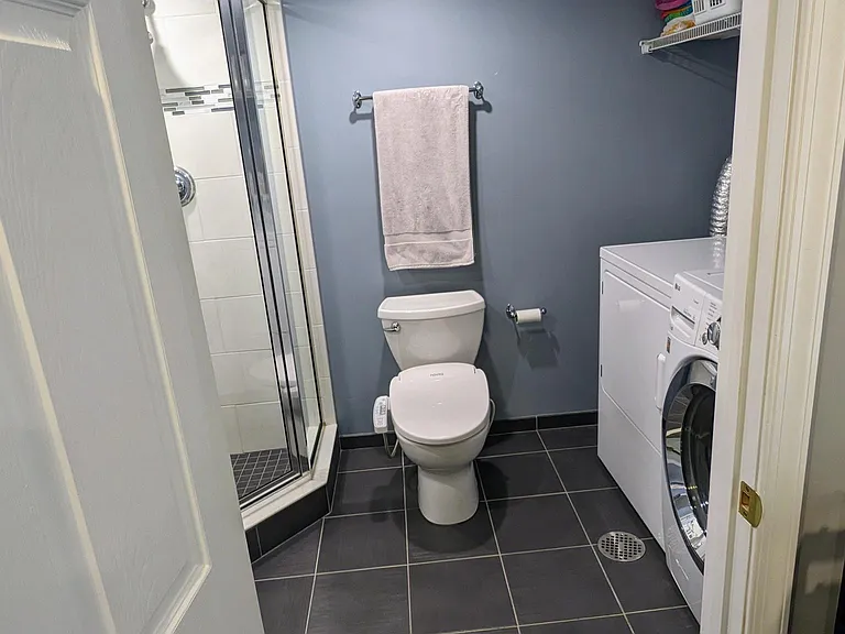 Basement bathroom serves as laundry room.