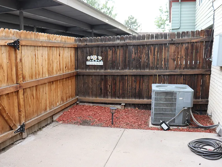 Back patio, AC unit, space for small garden.