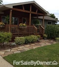 Front view of home with cedar porch.