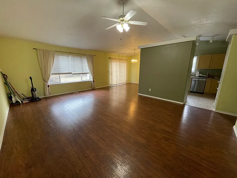 Main room view from front door. Back slider to back yard from dining area. Kitchen visible though open doorway.