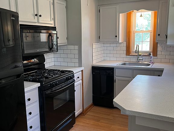 Brand new countertops and backsplash in kitchen. Freshly painted cupboards.
