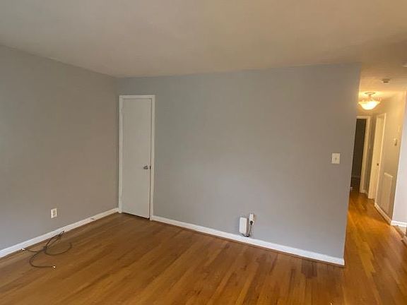Standing at the front door in the living room.