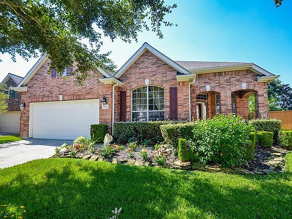 Exceptional landscaping makes this front exterior view so charming, in additon to a new roof, installed in 2020.