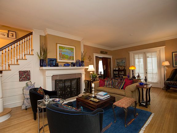 Large Formal Living Room with gorgeous hardwood floors and heavy crown moldings.