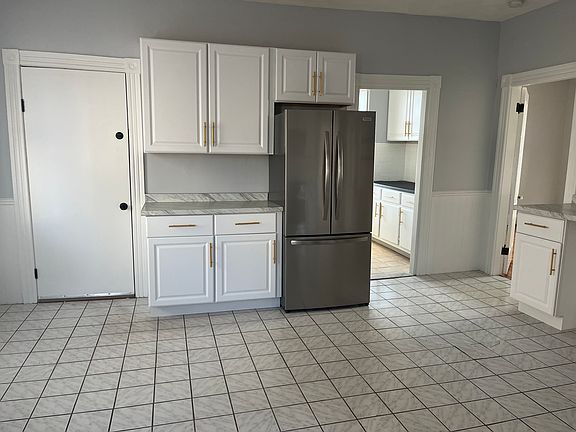 Kitchen leading to back door and laundry in basement