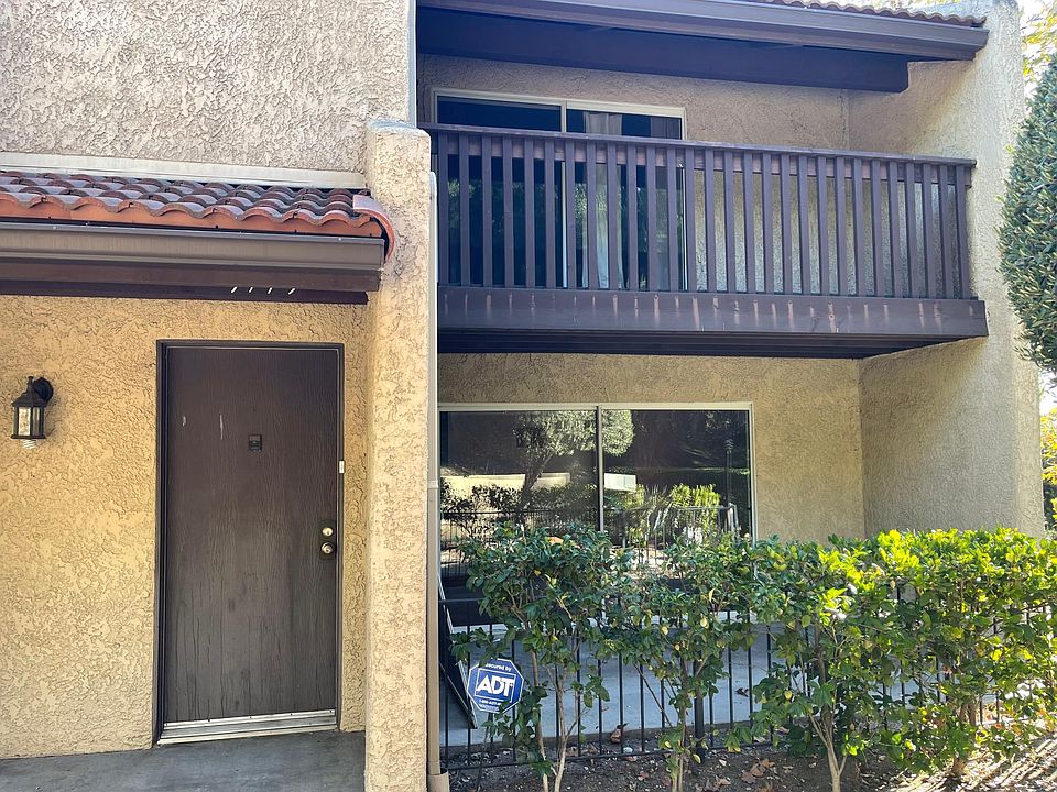 End unit with large patio and upstairs balcony